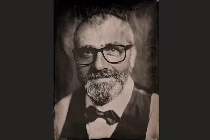 Man in glasses captured in 19th century metal plate portrait in Porto, Portugal, authentic tintype session