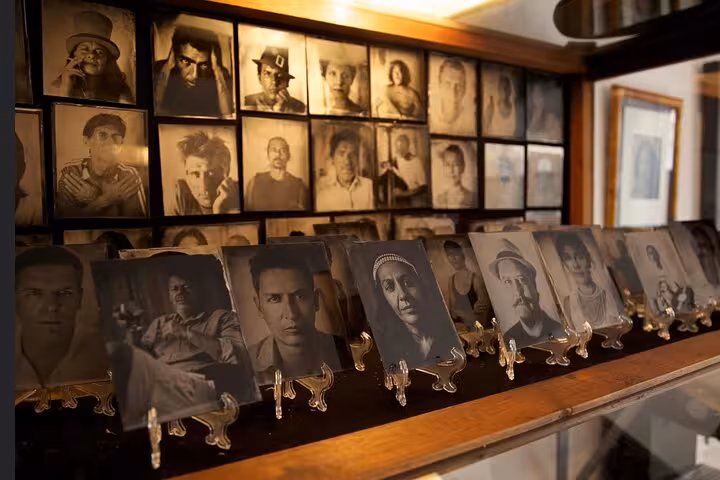 Gallery of historic tintype metal portraits in Porto studio, showcasing 19th century photography tour experience