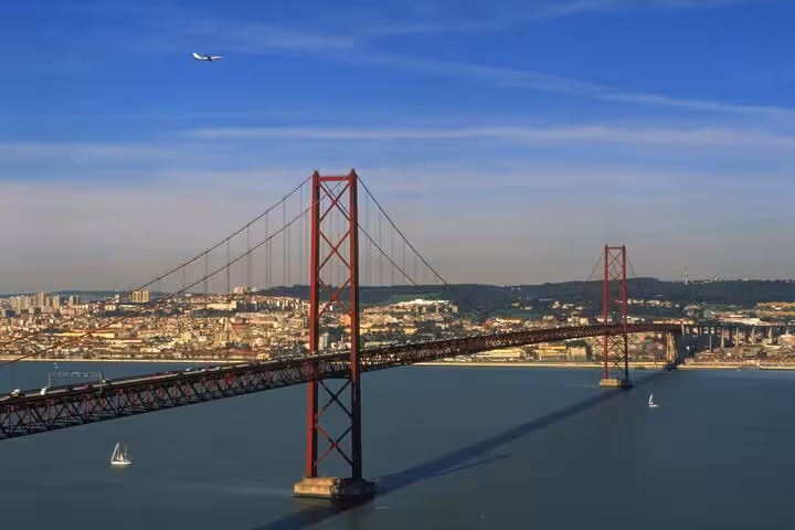 Marvel at the iconic 25 de Abril Bridge spanning the Tagus River in Lisbon, a highlight of your Portugal adventure.