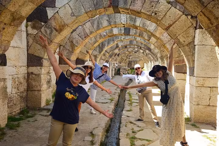 Tour group posing under ancient stone arches at Ephesus, Turkey on 4 Days 7 Churches of Revelation tour