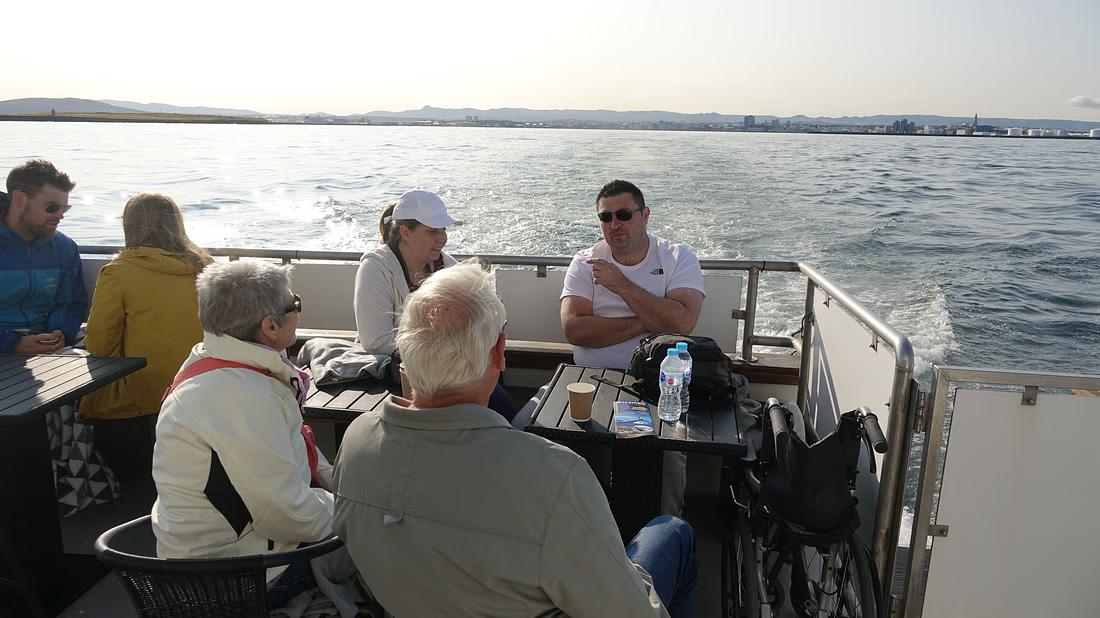 People sitting on deck of the Amelia Rose yacht