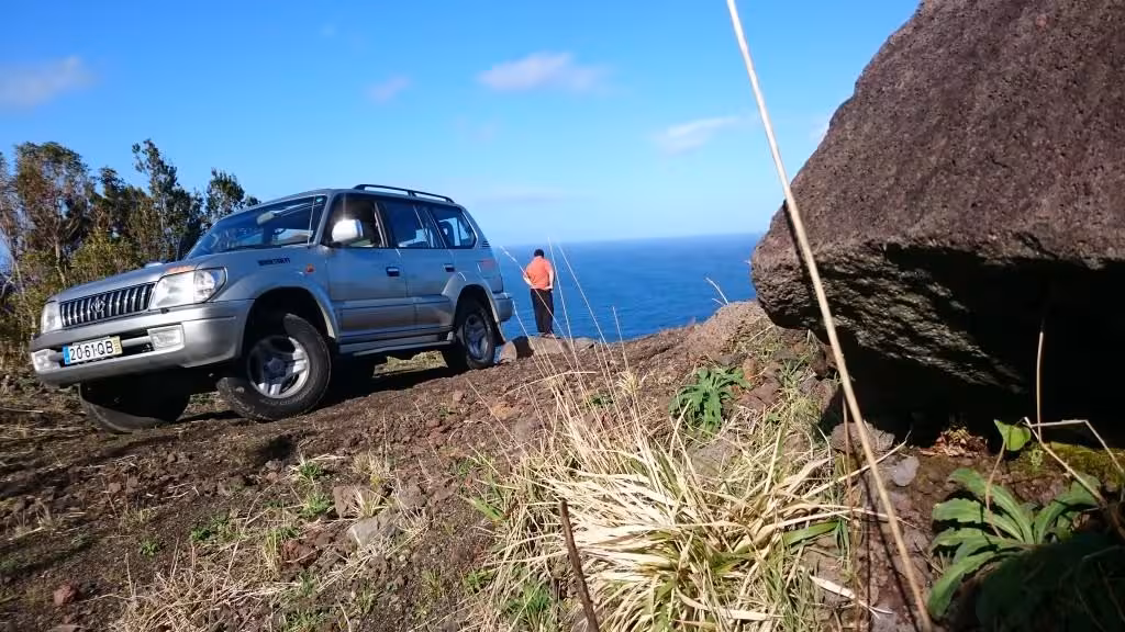4x4 jeep parked on a rugged coastal cliff near Ponta Delgada, offering off-road Azores adventure views over the Atlantic