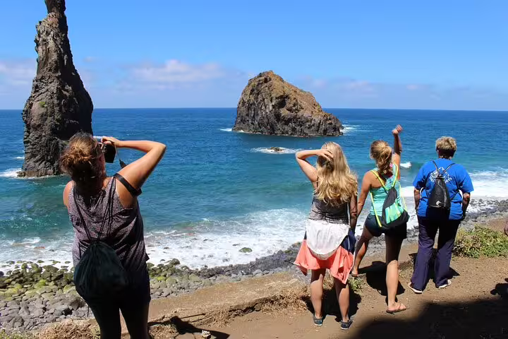 Tourists enjoy stunning ocean views and unique rock formations on a 4x4 Jeep adventure to Porto Moniz and Fanal, Madeira.