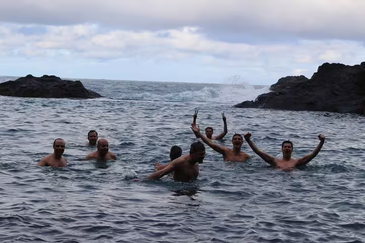 Tourists enjoy swimming in the natural ocean pools of Madeira's northwest coast during a full-day 4x4 adventure.