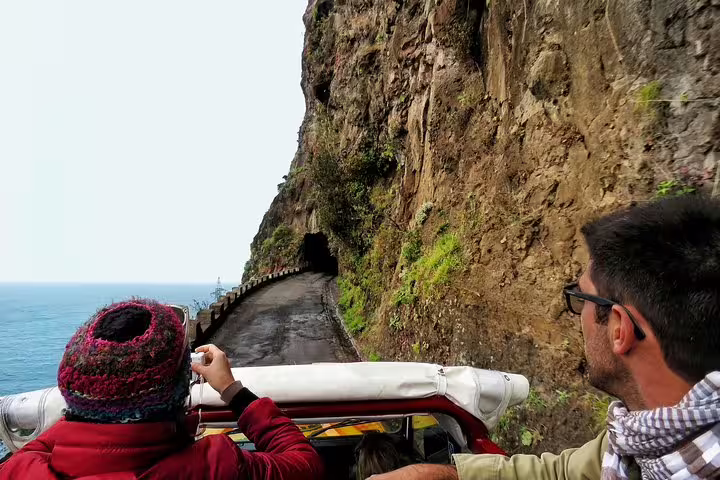4x4 tour along dramatic Portuguese coastal cliff road, offering breathtaking ocean views and thrilling adventure.