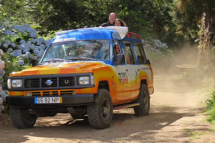 4x4 vehicle navigating a scenic vineyard trail surrounded by lush greenery on a Vineyard Escapade Wine Tour Adventure.