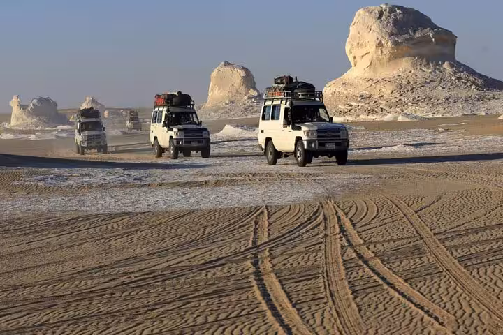 4x4 convoy crossing Egypt’s White Desert on a 3 days Eco Bahariya Oasis camping tour with rock formations