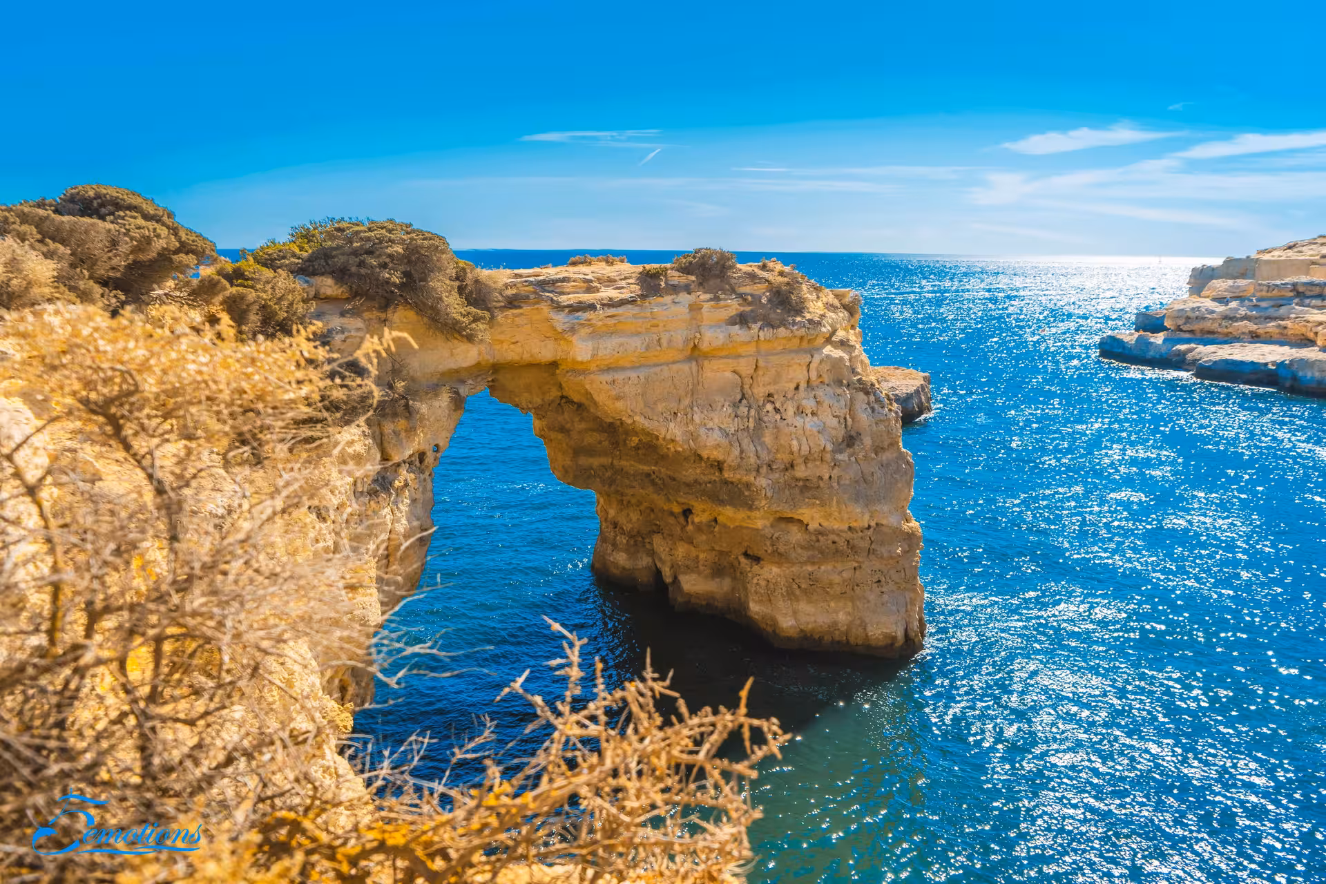 Stunning view of Benagil Caves' natural rock arch over sparkling ocean, ideal for Algarve coastal adventures.