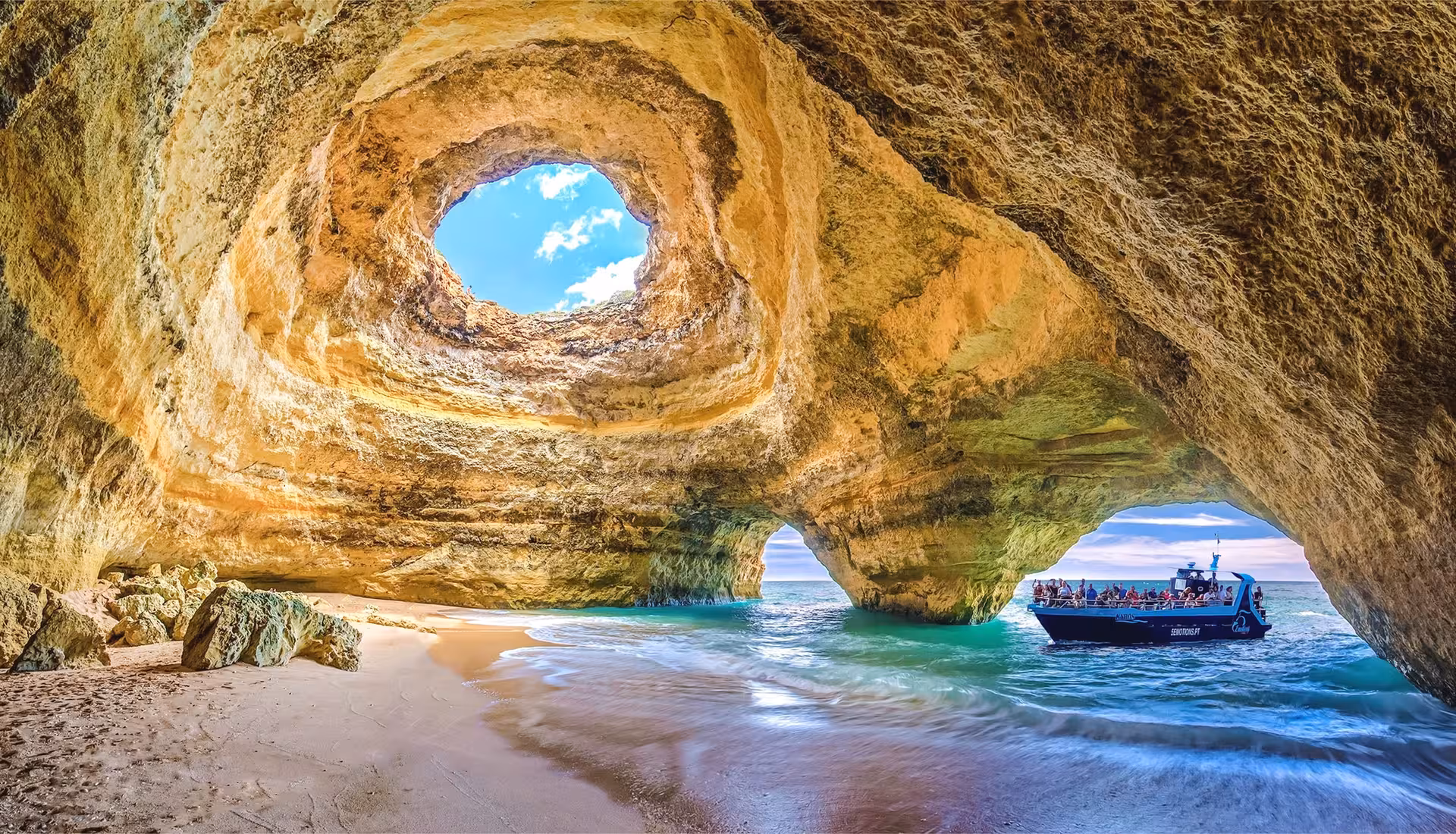 Explore the stunning Benagil Caves with a scenic boat tour along the Algarve Coast, featuring sandy beaches and azure waters.