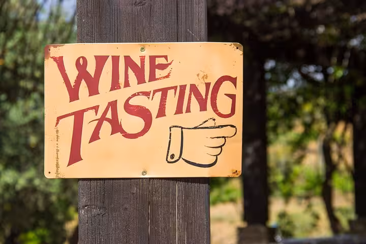 Rustic wine tasting directional sign at a boutique winery on the Albufeira and Silves wine tour in Algarve