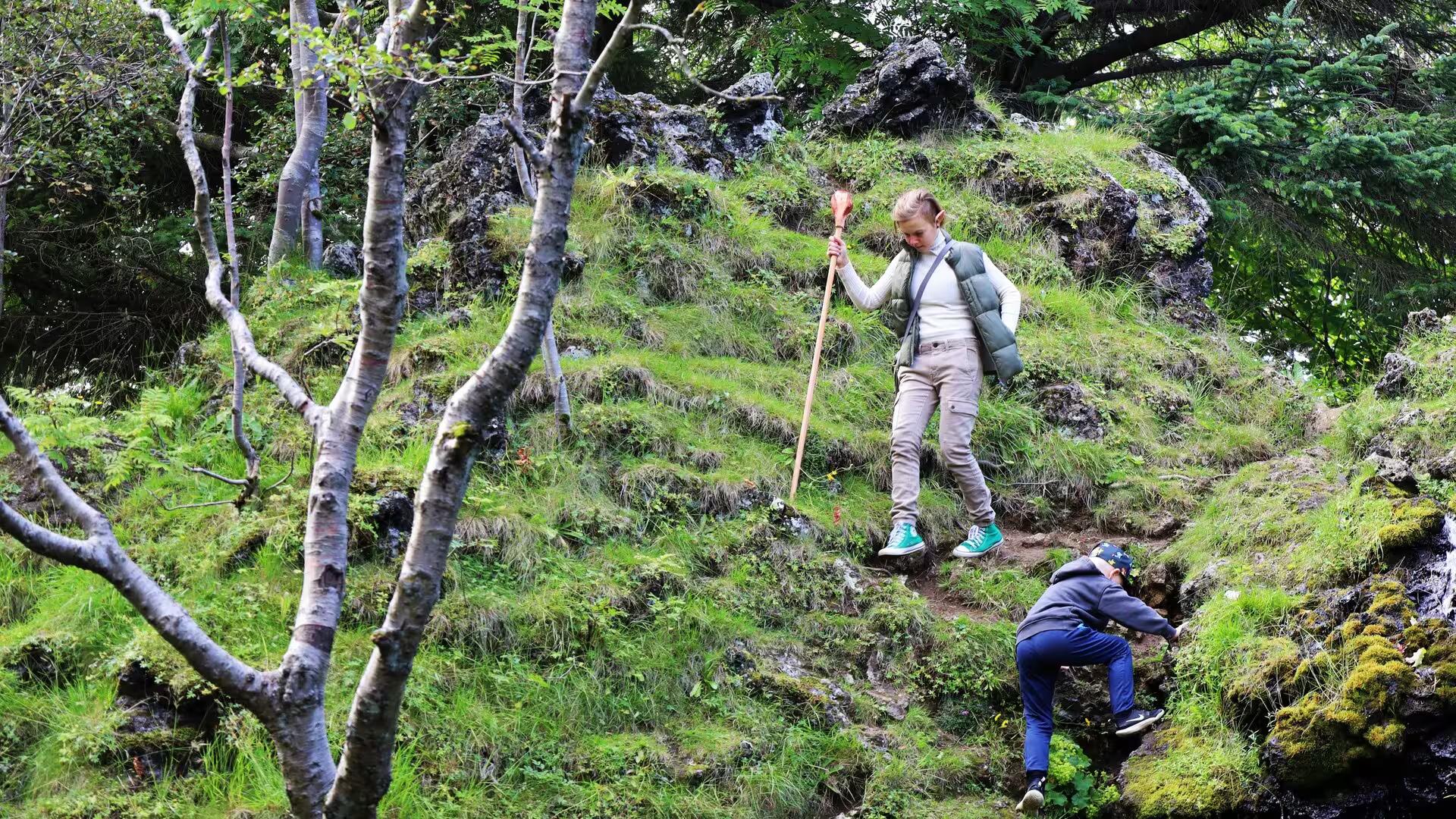Children exploring mossy lava rock trails on a Reykjavik Elves and Nature guided driving tour in Iceland