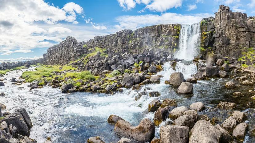 A picture of a waterfall that formed a rainbow in the centre. 