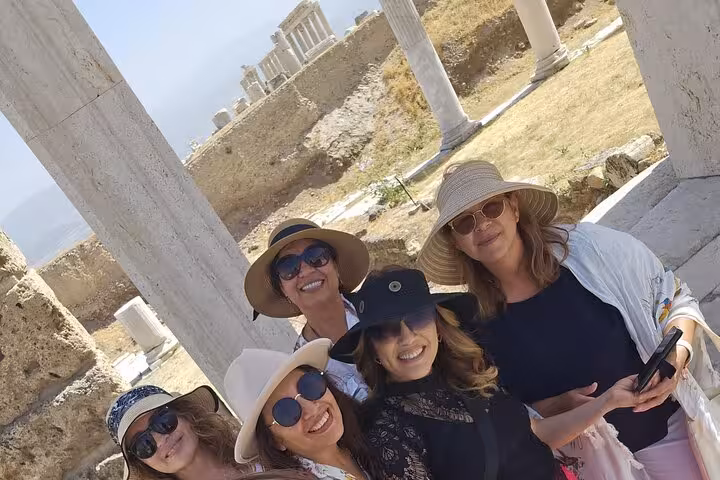 Tour guests smiling among white columns at ancient Sardis, a stop on the 4 Days 7 Churches Revelation Tour