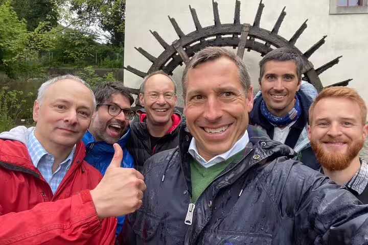 Group selfie at Aarau landmark on a self-guided scavenger hunt and sights tour, smiling outdoors in Switzerland