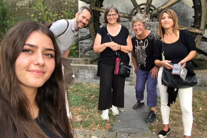 Group selfie at Aarau riverside waterwheel on an interactive scavenger hunt and sights self-guided tour