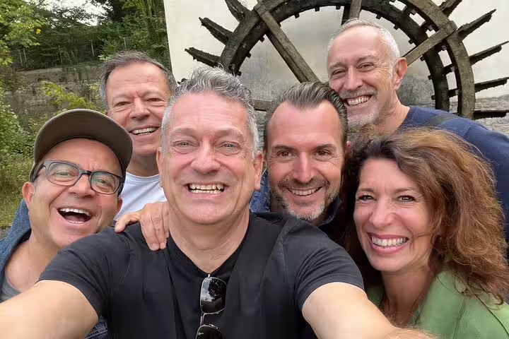 Group selfie at Aarau waterwheel stop on a self-guided scavenger hunt tour, exploring top city sights together