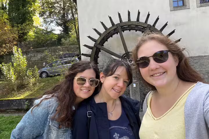 Friends selfie by historic waterwheel in Aarau, Switzerland, during a self-guided scavenger hunt sights tour
