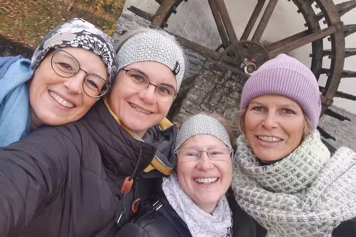 Friends selfie by Aarau waterwheel during self-guided scavenger hunt and sights tour in Switzerland
