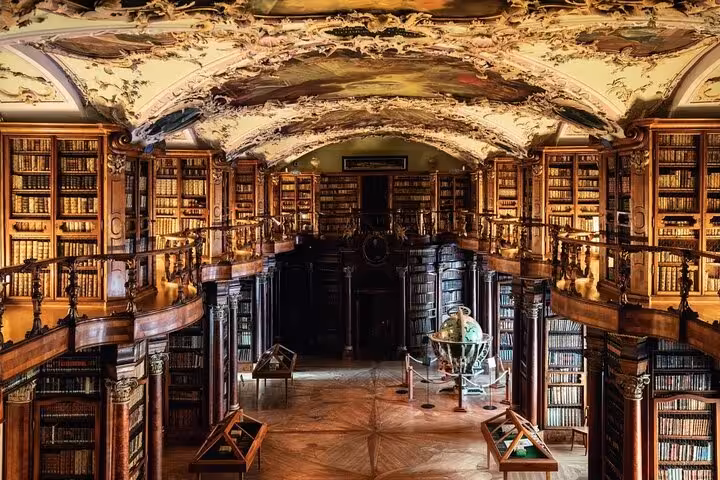 Ornate interior of the Abbey Library of St. Gallen, featuring intricate wooden shelves and a beautifully painted ceiling.