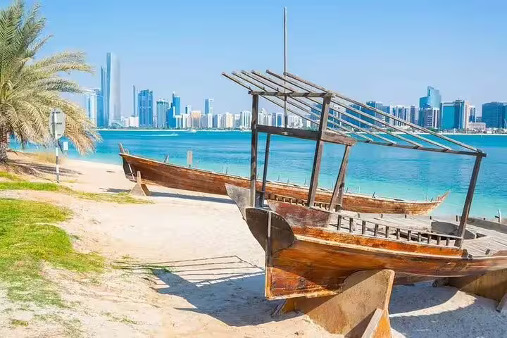 Discover Abu Dhabi's stunning skyline and traditional wooden boats along the azure coastline on a private 4x4 tour.