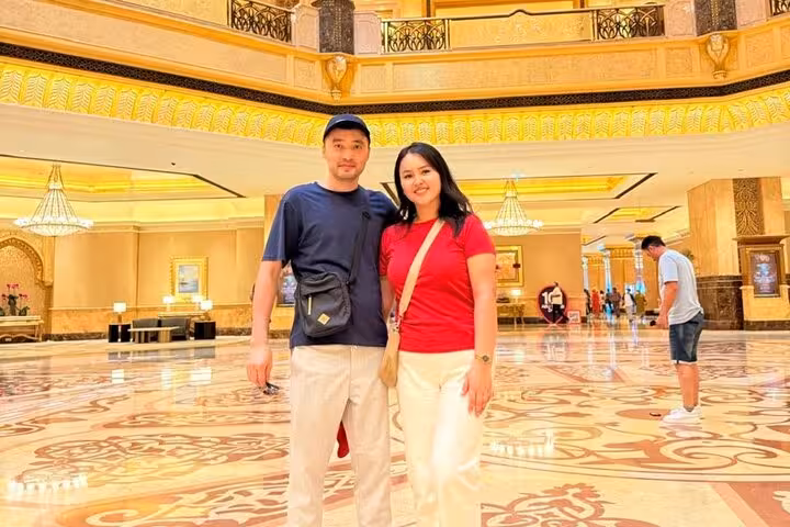 Tourists at Emirates Palace Abu Dhabi during city tour with Grand Mosque from Ras Al Khaimah