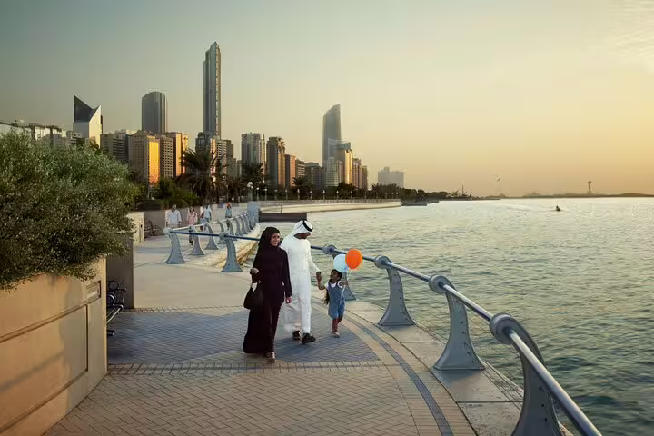 Stroll the Abu Dhabi Corniche at sunset with cityscape views and family-friendly ambiance on a private 4x4 tour.