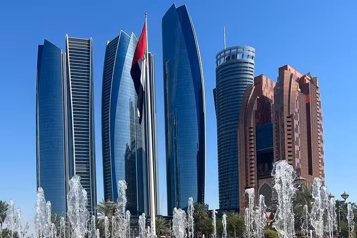 Etihad Towers skyline on Abu Dhabi city tour with coffee at 300M restaurant, fountains and UAE flag