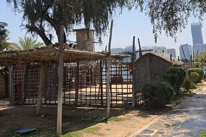 Heritage village huts on Abu Dhabi Corniche, a cultural stop on Ras Al Khaimah city tour to Grand Mosque