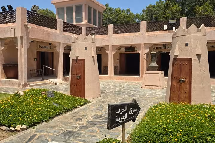 Heritage village courtyard in Abu Dhabi city tour from Ras Al Khaimah, traditional souk and towers