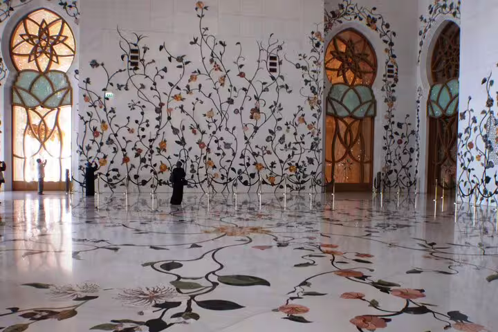 Intricate floral marble inlay inside Sheikh Zayed Grand Mosque, a highlight of the Private Abu Dhabi City Tour.