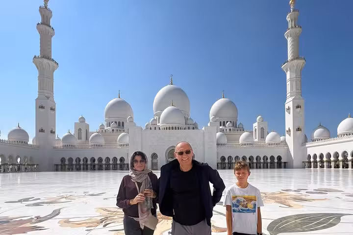 Family at Sheikh Zayed Grand Mosque on Abu Dhabi layover sightseeing tour with seamless airport transfer