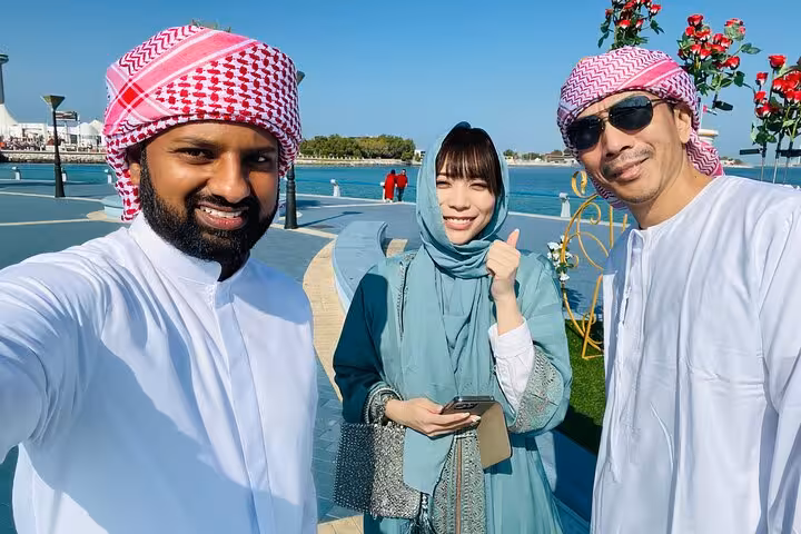 Abu Dhabi layover tour guests with local guide by Corniche waterfront, seamless airport transfer included