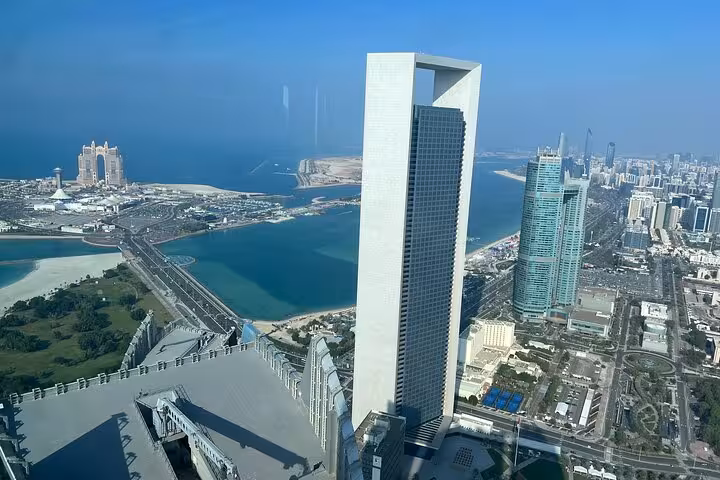 Panoramic Abu Dhabi skyline from Etihad Tower 300M restaurant, with Corniche lagoon and city tour views