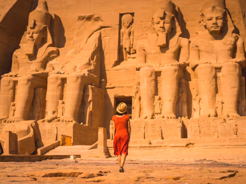 Traveler at Abu Simbel temples, iconic Ramses II statues on Best of Egypt 5-star Nile cruise tour