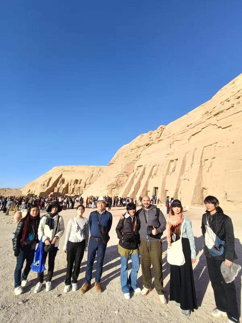 Travelers group photo at Abu Simbel Temples on Aswan early morning tour with guide, transport and pickup