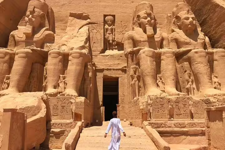Traveler walking to Abu Simbel Great Temple entrance on private guided day tour from Aswan by flight