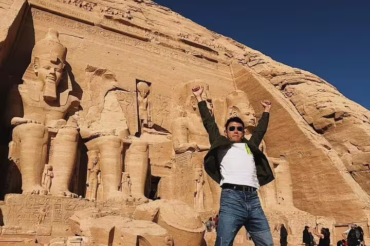 Tourist posing at Abu Simbel Great Temple on private guided day tour from Aswan by flight, Egypt