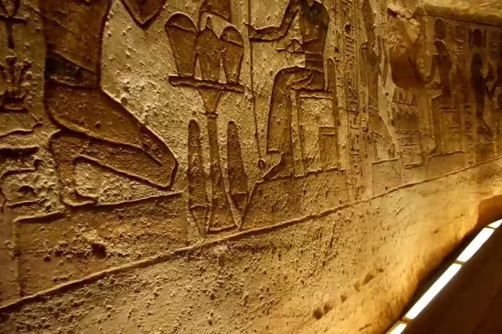 Ancient hieroglyph relief corridor at Abu Simbel Temples, guided day trip from Aswan Egypt