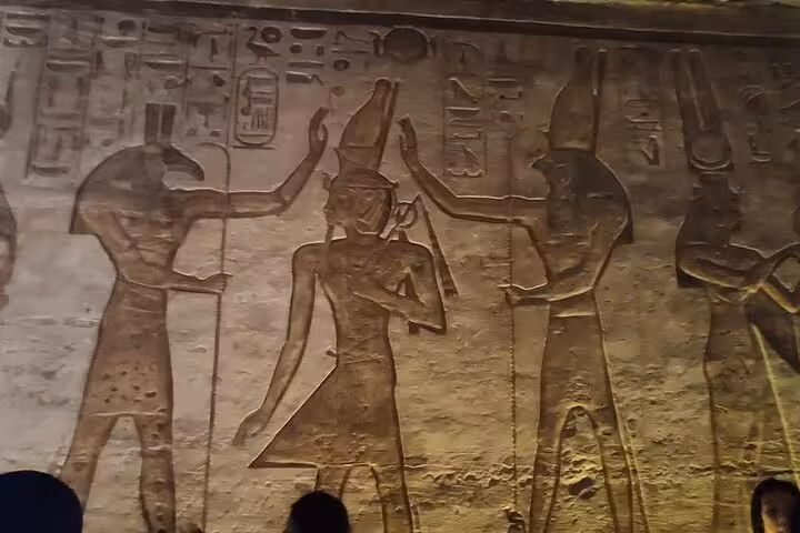 Ancient wall carvings and hieroglyphs inside Abu Simbel temple on private day trip from Aswan