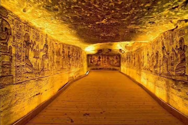 Illuminated corridor with ancient hieroglyphs inside Abu Simbel Temple, Aswan day trip guided tour
