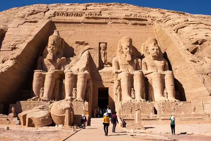 Great Temple of Abu Simbel facade with colossal Ramses II statues, overnight Luxor to Aswan tour stop