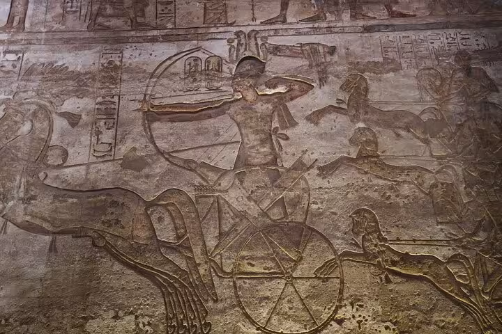 Ancient wall relief carvings at Abu Simbel temple on a private day trip from Aswan with pickup