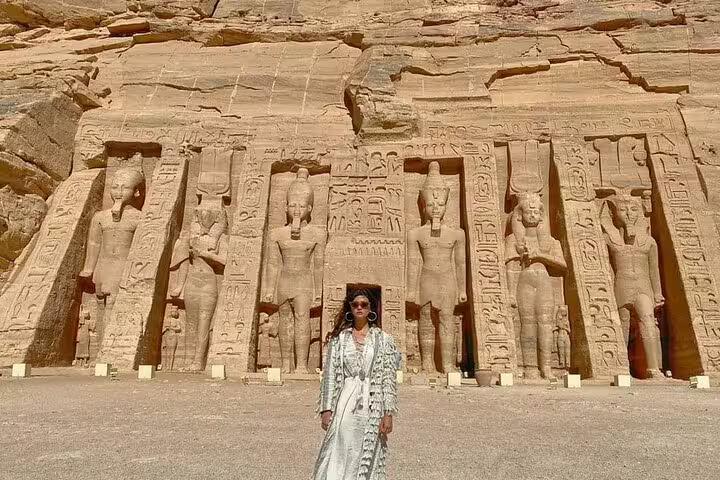 Traveler at Abu Simbel Great Temple statues on private guided day tour from Aswan by flight, Egypt