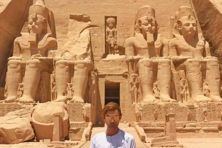 Visitor at Abu Simbel Temples facade during private guided day trip from Aswan with roundtrip flight
