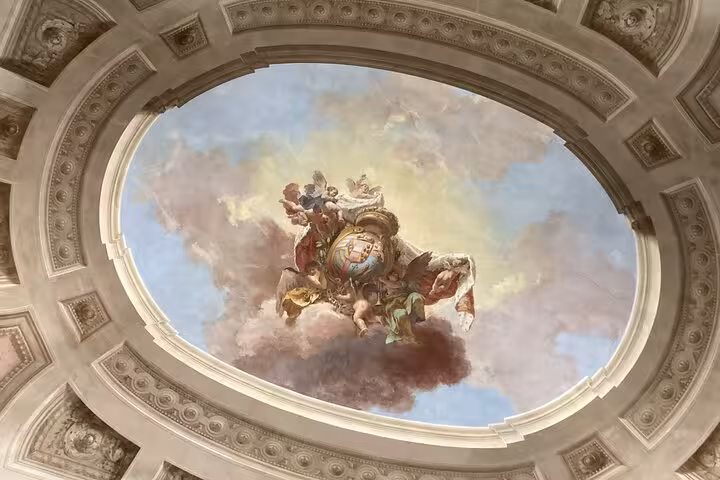 Ornate ceiling fresco in the Accademia Gallery, showcasing exquisite artistry on a small-group tour.
