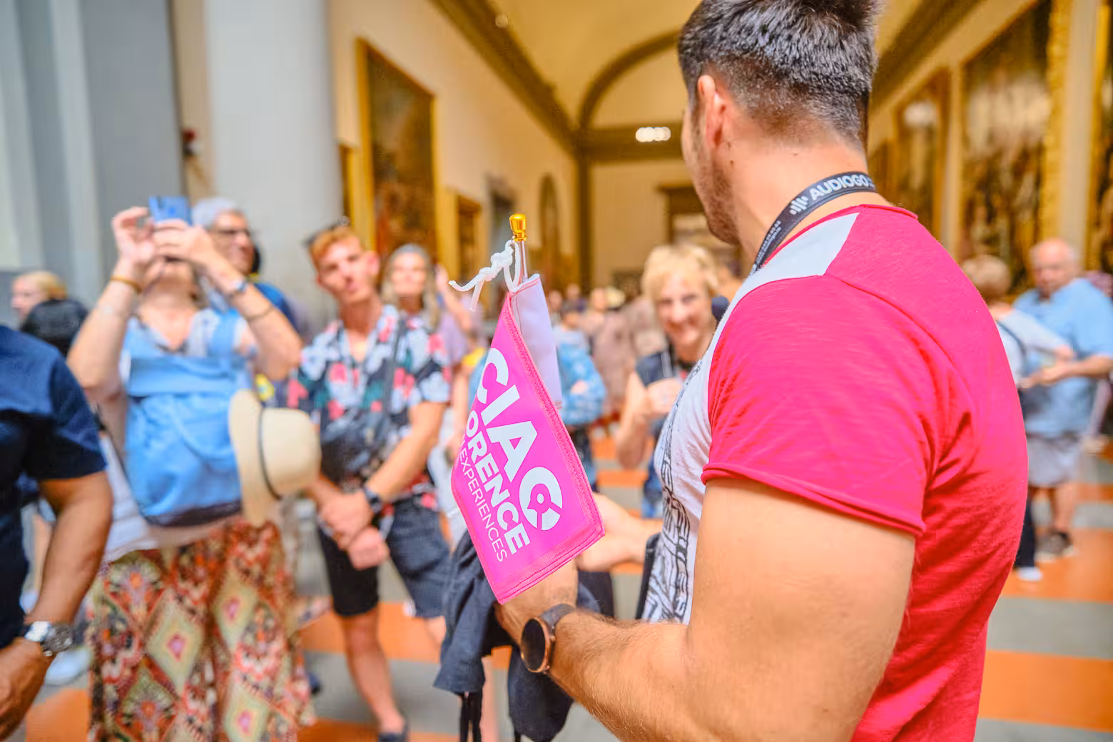 A tour guide leads a group through Accademia Gallery, showcasing Florence's Renaissance art with skip-the-line tickets.