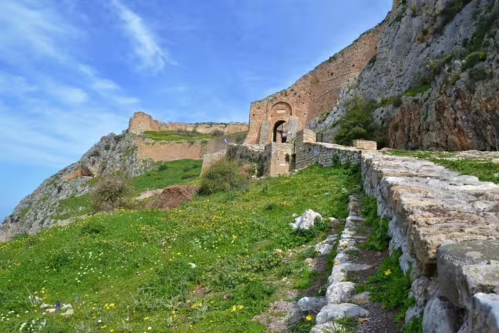 Acrocorinth fortress walls and arched gate above Corinth on Ancient Corinth half-day tour from Athens