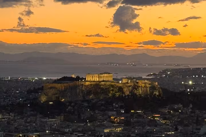 Acropolis and Parthenon glowing at sunset, seen on Athens airport transfer express city highlights tour