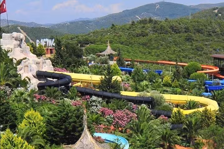 Panoramic Adaland Aquapark Kusadasi water slides amid lush hills, part of private Ephesus shore tour