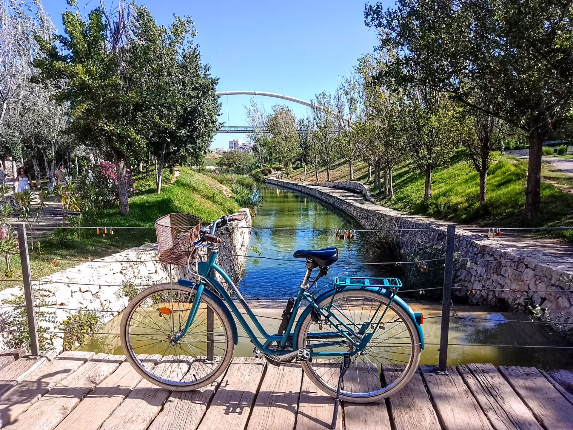 Adult city bike rental with basket on a wooden bridge over a canal, perfect for scenic city cycling and tours
